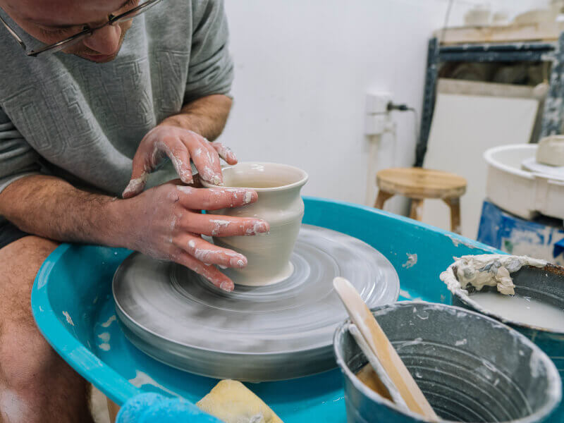 Man scultping clay on the wheel